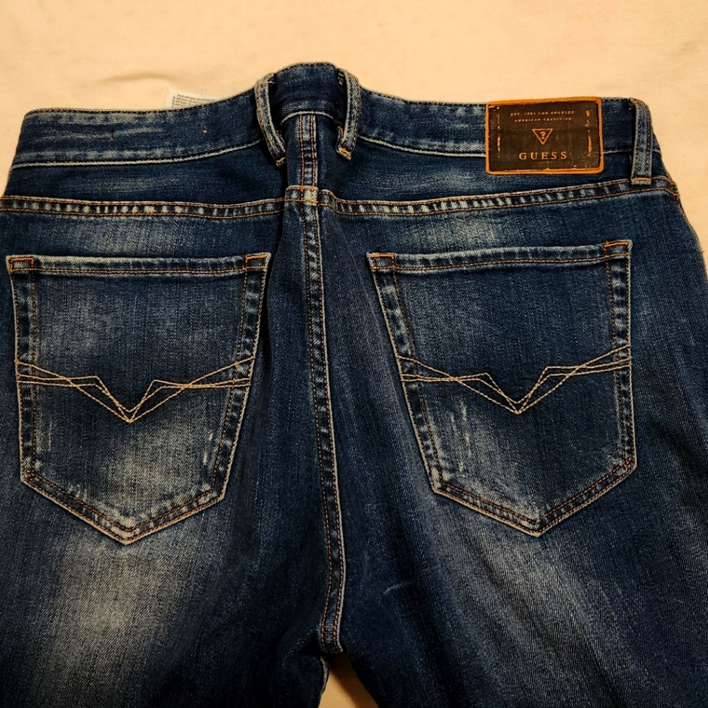 Relaxed fit GUESS jeans, size 32 in distressed indigo